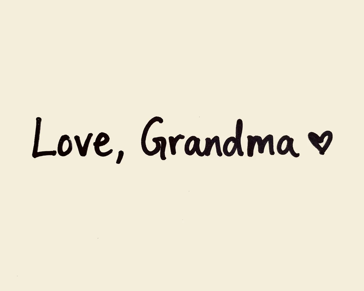 The handwritten words "Love, Grandma" and a small heart in black felt-pen ink on a cream card